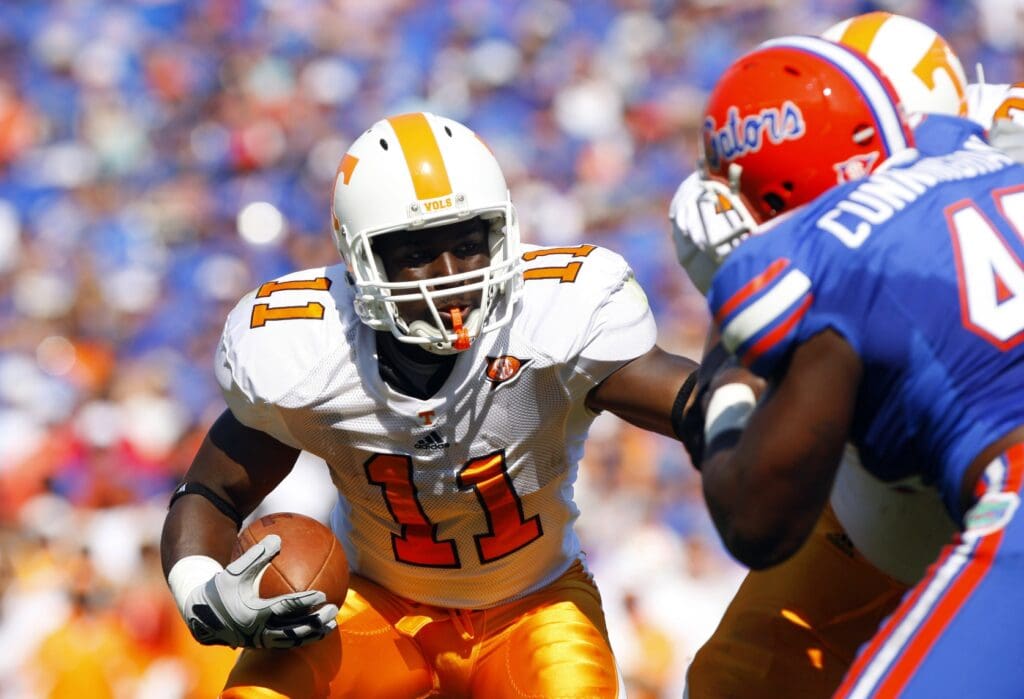 September 19, 2009; Gainesville FL, USA; Tennessee running back Bryce Brown (11) runs with the ball as Florida defensive end Jermaine Cunningham attmepts to stop him during the first half at Ben Hill Griffin Stadium.