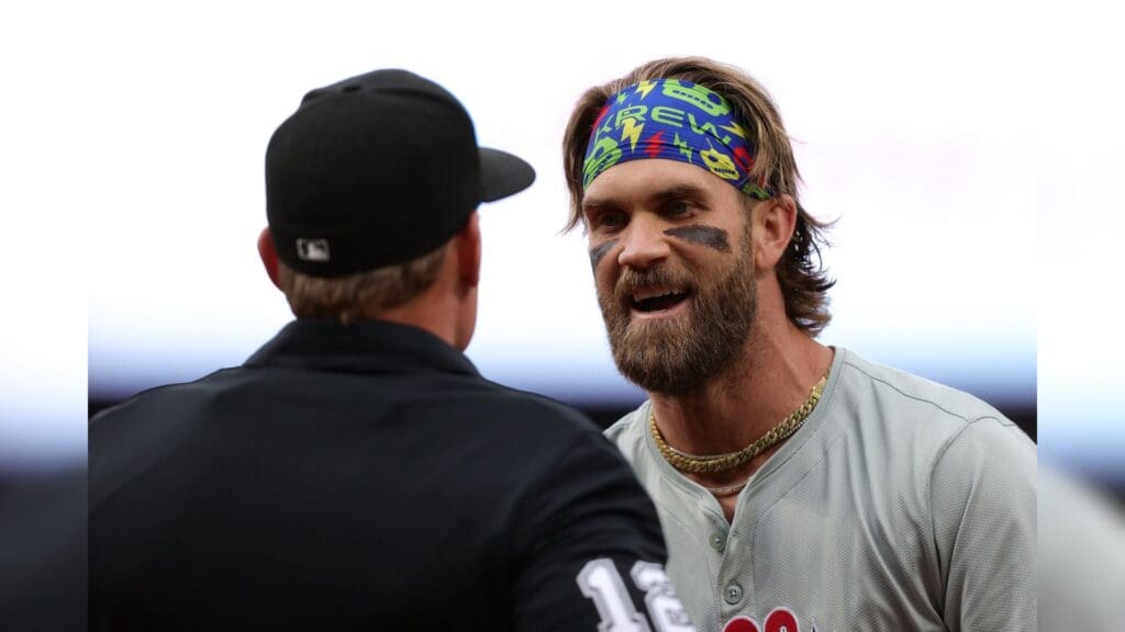 May 24, 2024; Denver, Colorado, USA; Philadelphia Phillies first baseman Bryce Harper (3) argues with home plate umpire Brian Walsh (120) after being ejected in the first inning against the Colorado Rockies at Coors Field.
