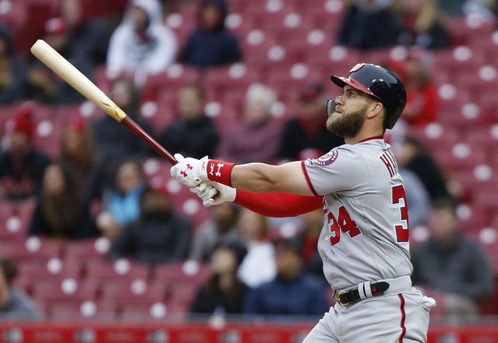 Apr 1, 2018; Cincinnati, OH, USA; Washington Nationals right fielder Bryce Harper hits a solo home run during the ninth inning against the Cincinnati Reds at Great American Ball Park.