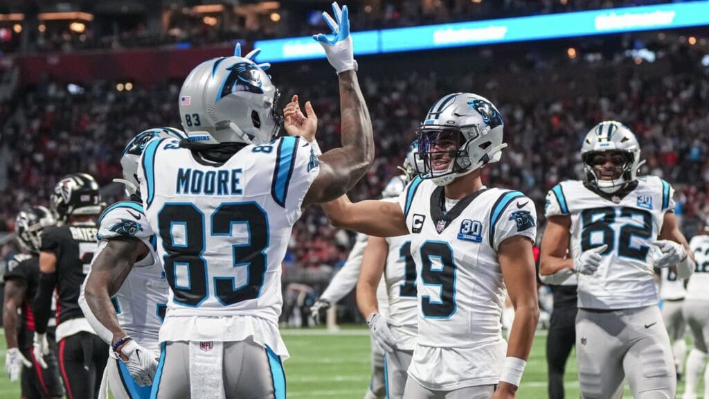 Jan 5, 2025; Atlanta, Georgia, USA; Carolina Panthers quarterback Bryce Young (9) reacts with wide receiver David Moore (83) after running for a touchdown against the Atlanta Falcons during the second half at Mercedes-Benz Stadium.