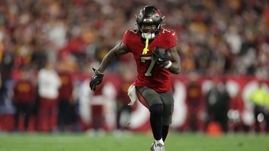 Jan 12, 2025; Tampa, Florida, USA; Tampa Bay Buccaneers running back Bucky Irving (7) runs during the fourth quarter of a NFC wild card playoff against the Washington Commanders at Raymond James Stadium.