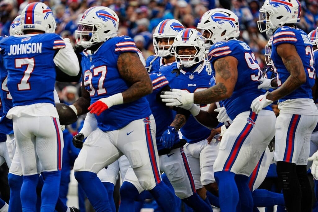 Buffalo Bills defensive tackle Jordan Phillips (97) celebrates with his team his intercepting New York Jets quarterback Aaron Rodgers (8) pass intended for a receiver during first half action at the Bills home game against the New York Jets at Highmark Stadium in Orchard Park on Dec. 29, 2024.