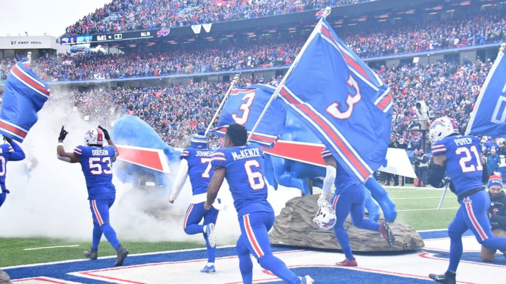 Jan 8, 2023; Orchard Park, New York, USA; Buffalo Bills players enter the field before a game against the New England Patriots carrying #3 flags for Damar Hamlin at Highmark Stadium.