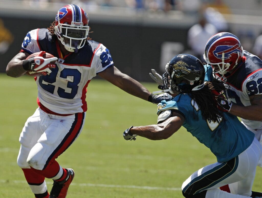September 14, 2008; Jacksonville, FL, USA; Buffalo Bills running back Marshawn Lynch (23) fights off a tackle by Jacksonville Jaguars defensive back Rashean Mathis (27) in the first half at Jacksonville Municipal Stadium.