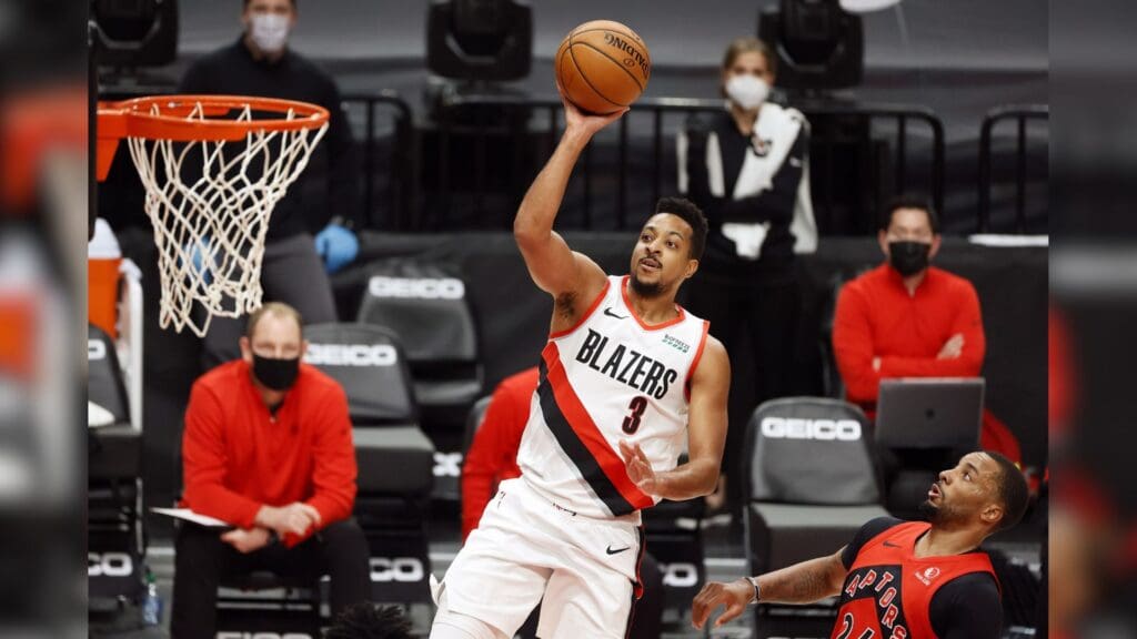 Jan 11, 2021; Portland, Oregon, USA; Portland Trail Blazers shooting guard CJ McCollum (3) shoots the ball past Toronto Raptors shooting guard Norman Powell (R) during the first half at Moda Center.