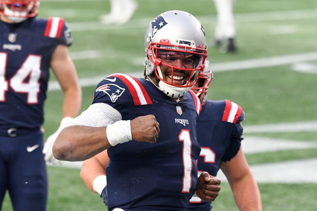 Jan 3, 2021; Foxborough, Massachusetts, USA; New England Patriots quarterback Cam Newton (1) celebrates after scoring a touchdown against the New York Jets during the third quarter at Gillette Stadium.