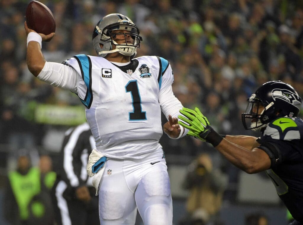 January 10, 2015; Seattle, WA, USA; Carolina Panthers quarterback Cam Newton (1) throws under pressure against the defense of Seattle Seahawks outside linebacker K.J. Wright (50) during the first half in the 2014 NFC Divisional playoff football game at CenturyLink Field.