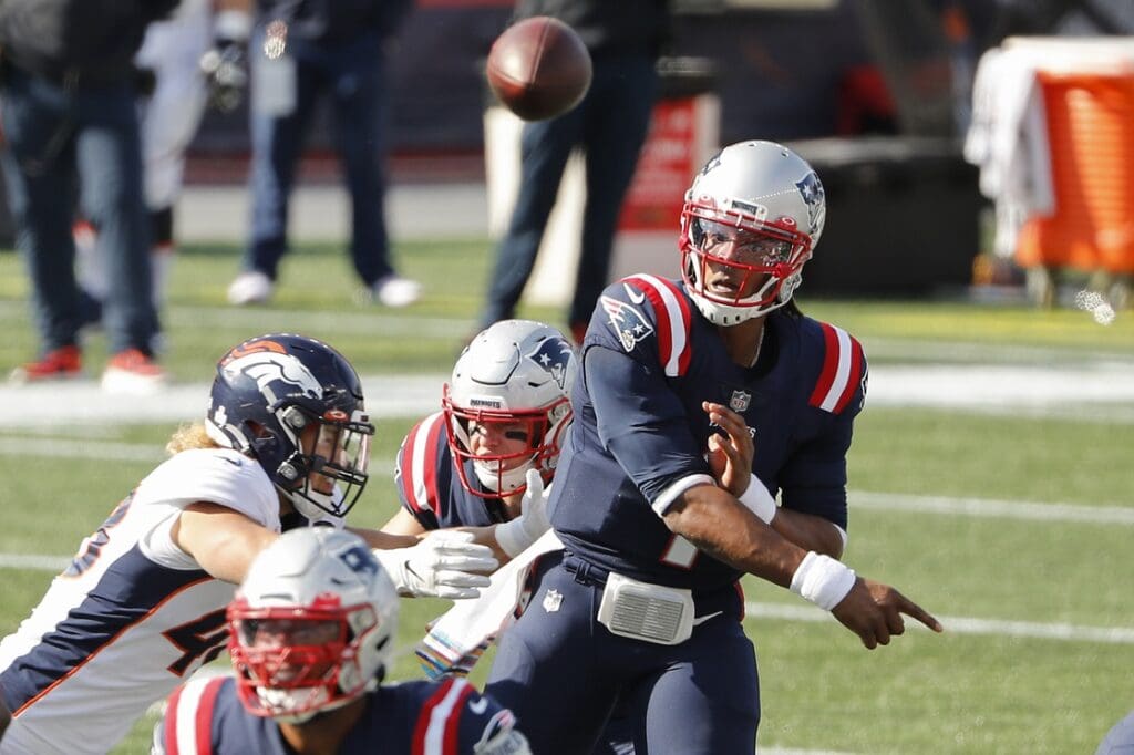 Oct 18, 2020; Foxborough, Massachusetts, USA; New England Patriots quarterback Cam Newton (1) throws under pressure from Denver Broncos linebacker Derrek Tuszka (48) during the second quarter at Gillette Stadium