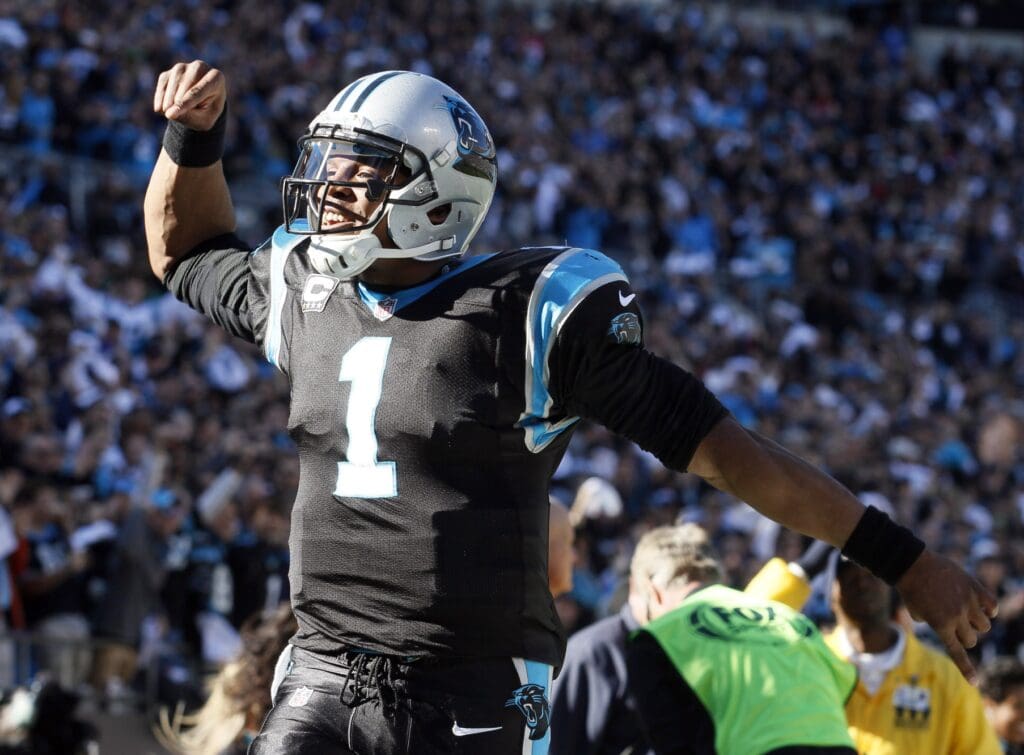 Jan 12, 2014; Charlotte, NC, USA; Carolina Panthers quarterback Cam Newton (1) celebrates a passing touchdown against the San Francisco 49ers during the first half of the 2013 NFC divisional playoff football game at Bank of America Stadium.