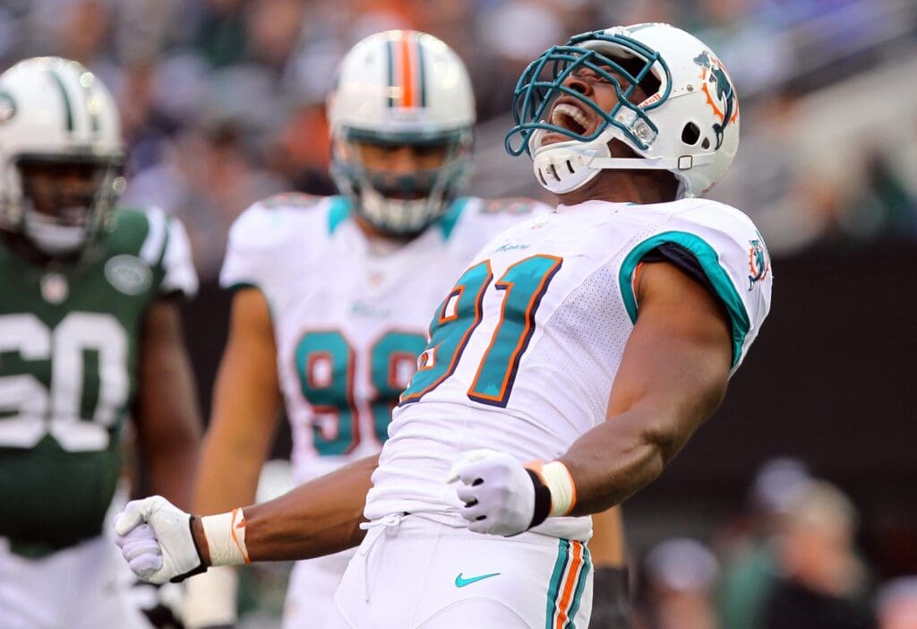 Oct 28, 2012; East Rutherford, NJ, USA; Miami Dolphins defensive end Cameron Wake (91) celebrates his sack of New York Jets quarterback Mark Sanchez (6) (not pictured) during the first half at MetLIfe Stadium.