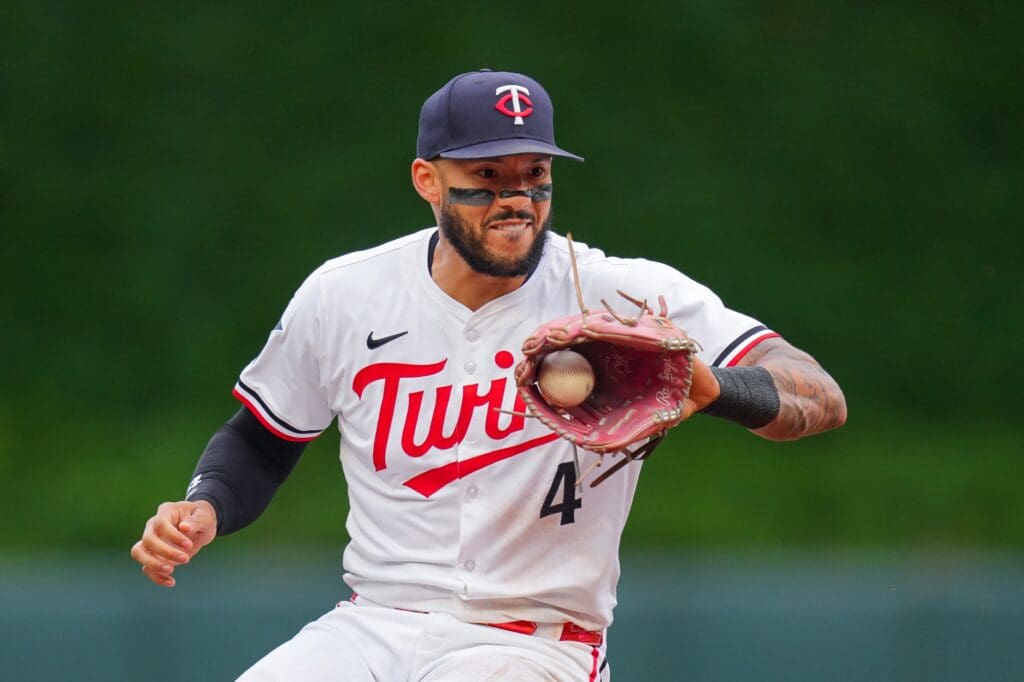 Jun 25, 2025; Minneapolis, Minnesota, USA; Minnesota Twins shortstop Carlos Correa (4) fields a ground ball against the Seattle Mariners in the second inning at Target Field.