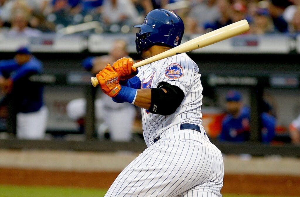 Jun 15, 2019; New York City, NY, USA; New York Mets center fielder Carlos Gomez (91) hits an RBI sacrifice fly against the St. Louis Cardinals during the first inning at Citi Field.