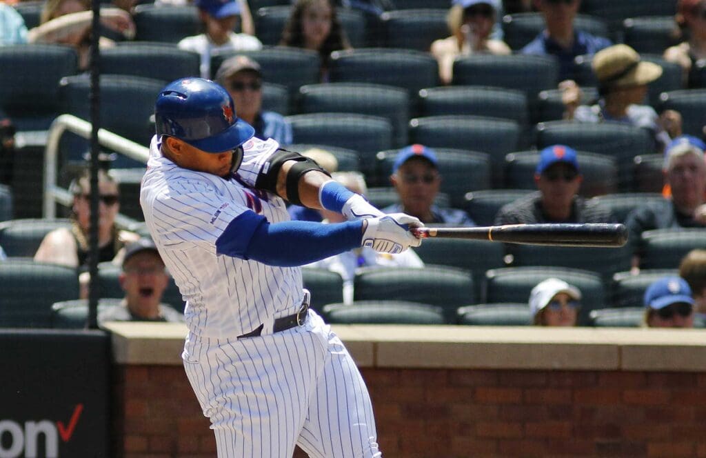 Jun 9, 2019; New York City, NY, USA; New York Mets center fielder Carlos Gomez (91) hits an RBI single against the Colorado Rockies during the fourth inning at Citi Field.
