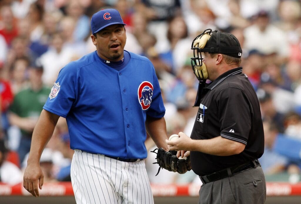 Jun 18, 2009; Chicago, IL, USA; Chicago Cubs starting pitcher Carlos Zambrano (left) talks with home plate umpire Bruce Dreckman (right) after hitting a Chicago White Sox batter during the second inning at Wrigley Field.