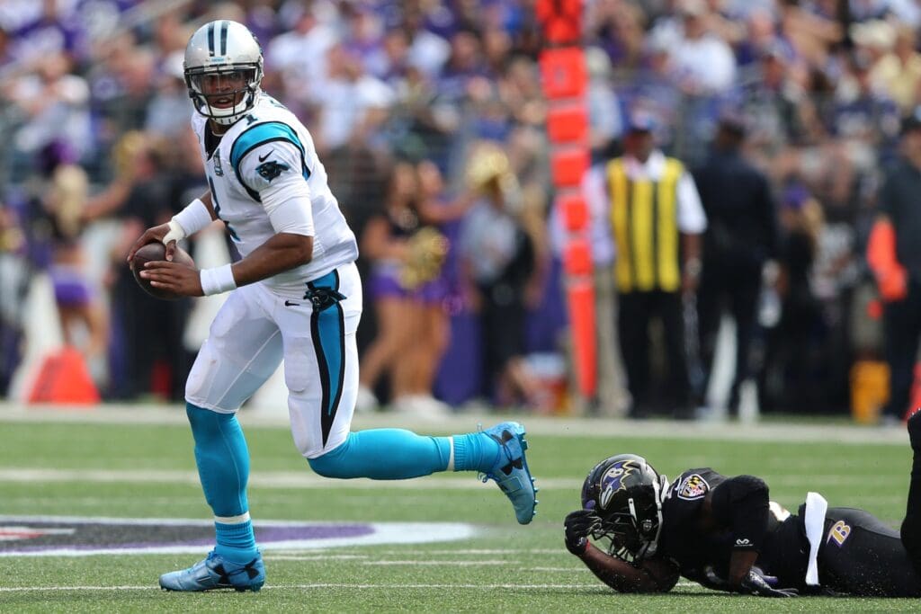 Sep 28, 2014; Baltimore, MD, USA; Carolina Panthers quarterback Cam Newton (1) scrambles with the ball against the Baltimore Ravens at M&T Bank Stadium.