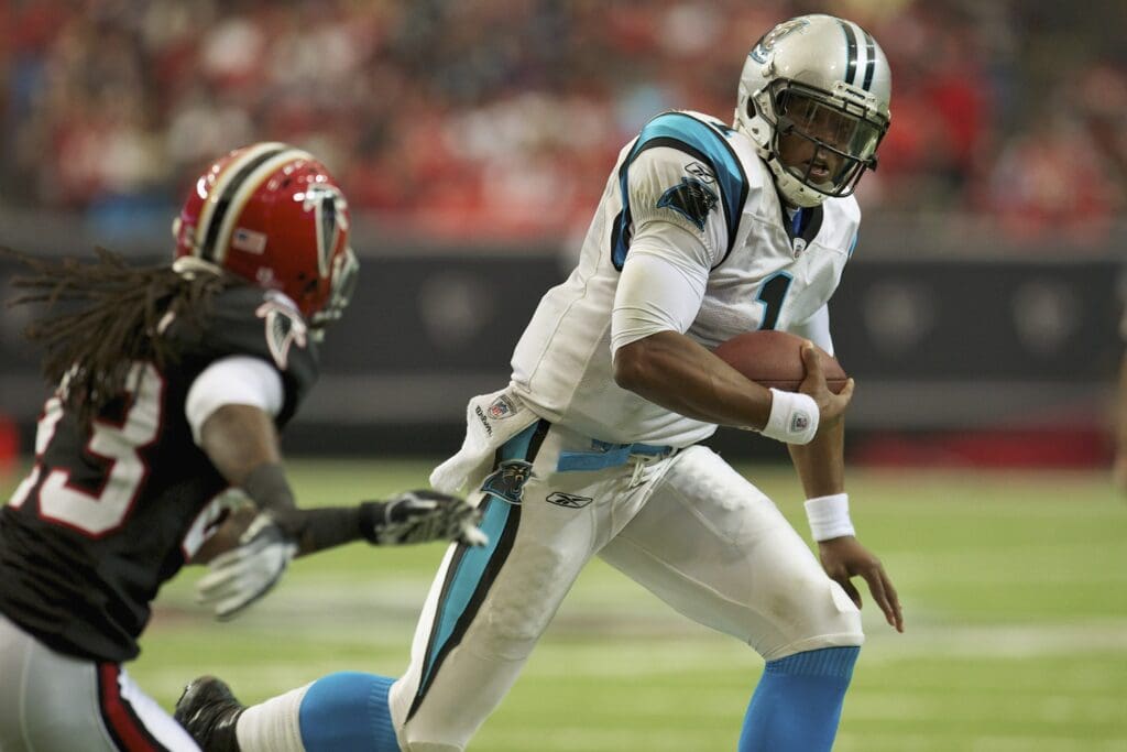 Oct 16, 2011; Atlanta, GA, USA; Carolina Panthers quarterback Cam Newton (1) runs past Atlanta Falcons cornerback Dunta Robinson (23) to score a touchdown during the third quarter at the Georgia Dome. The Falcons defeated the Panthers 31-17.