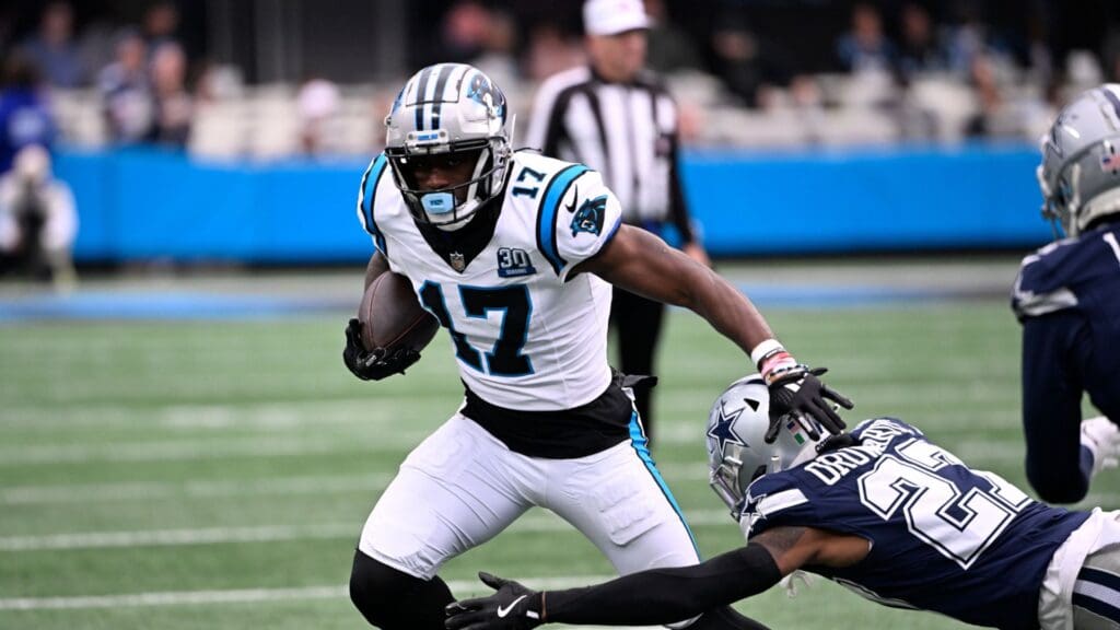 Dec 15, 2024; Charlotte, North Carolina, USA; Carolina Panthers wide receiver Xavier Legette (17) with the ball as Dallas Cowboys cornerback Amani Oruwariye (27) defefends in the first quarter at Bank of America Stadium