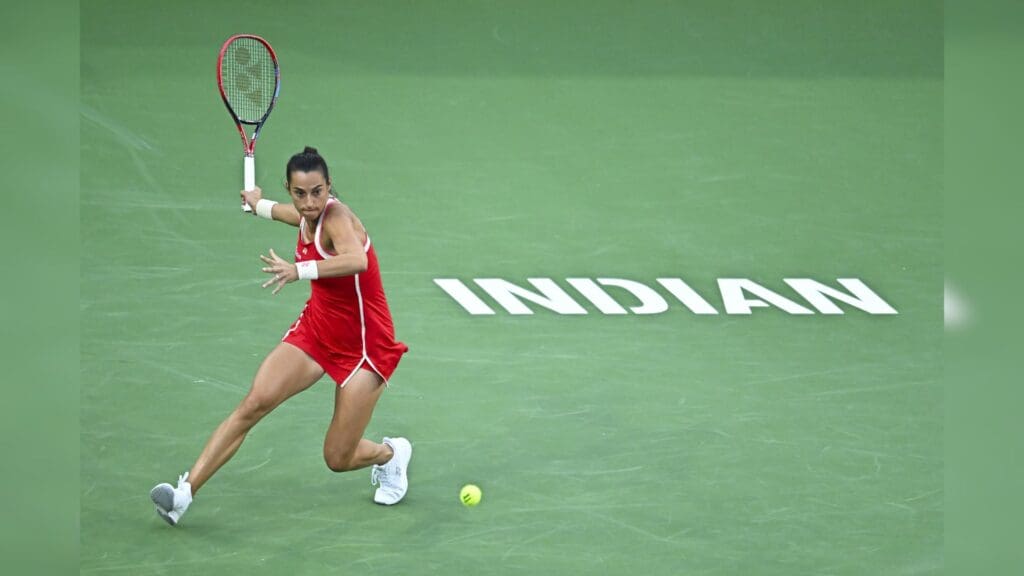 Mar 7, 2025; Indian Wells, CA, USA; Caroline Garcia (FRA) hits a ball against Iga Swiatek (POL) at Indian Well Tennis Garden.