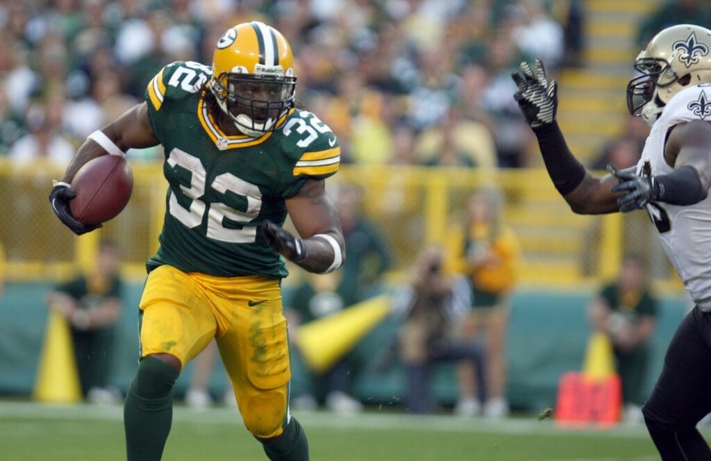 Sept. 30, 2012; Green Bay, WI, USA; Green Bay Packers running back Cedric Benson (32) runs against a New Orleans Saints defender at Lambeau Field. The Green Bay Packers defeated the New Orleans Saints 28-27.