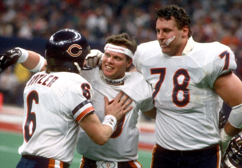 Jan 26, 1986; New Orleans, LA, USA; FILE PHOTO; Chicago Bears quarterback #9 Jim McMahon hugs teammates #6 kicker Kevin Butler and #78 tackle Keith VanHorne during Super Bowl XX against the New England Patriots at the Superdome. The Bears defeated the Patriots 46-10.