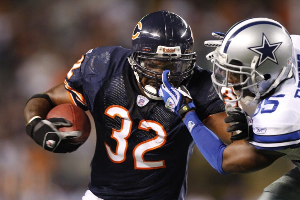 Sep 23, 2007; Chicago, IL, USA; Chicago Bears running back Cedric Benson (32) runs against Dallas Cowboys cornerback Jacques Reeves (35) in the first quarter at Soldier Field Stadium.