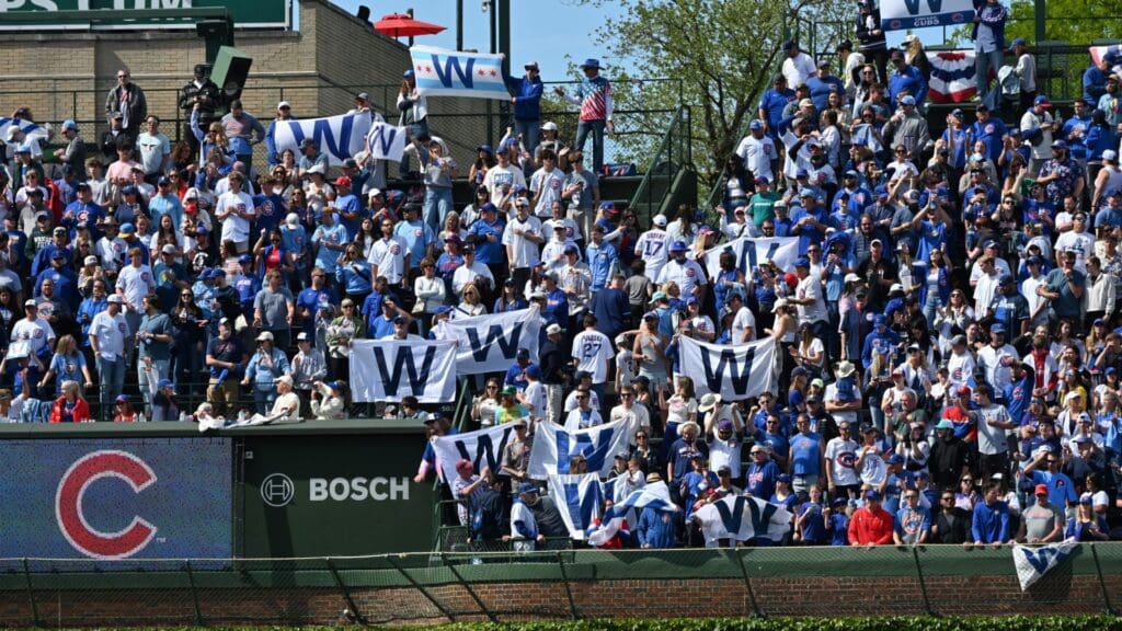 May 26, 2025; Chicago, Illinois, USA; Chicago Cubs fans hold up W flags after their team defeats the Colorado Rockies at Wrigley Field.