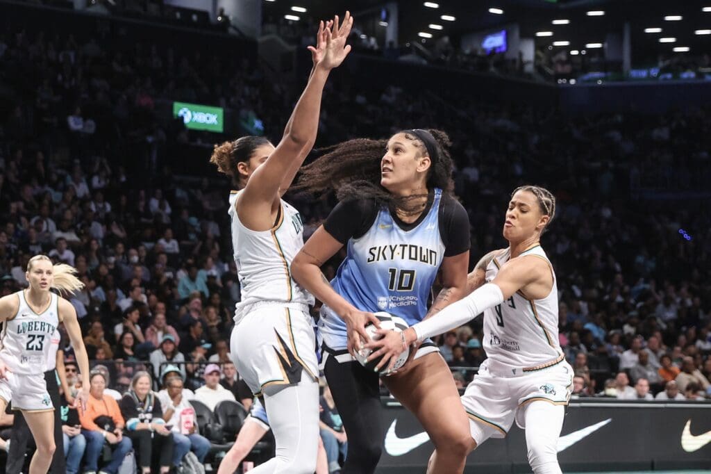 Jun 10, 2025; Brooklyn, New York, USA; Chicago Sky center Kamilla Cardoso (10) is double teammed by New York Liberty center Nyara Sabally (8) and guard Natasha Cloud (9) in the second quarter at Barclays Center.