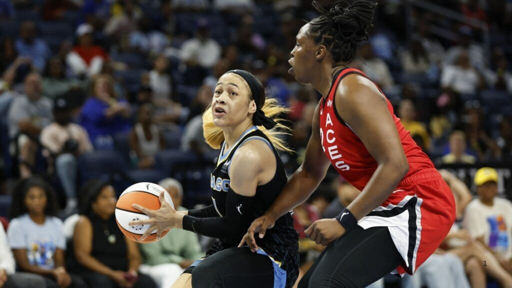 Aug 25, 2024; Chicago, Illinois, USA; Chicago Sky guard Chennedy Carter (7) drives to the basket against Las Vegas Aces guard Chelsea Gray (12) during the first half at Wintrust Arena.