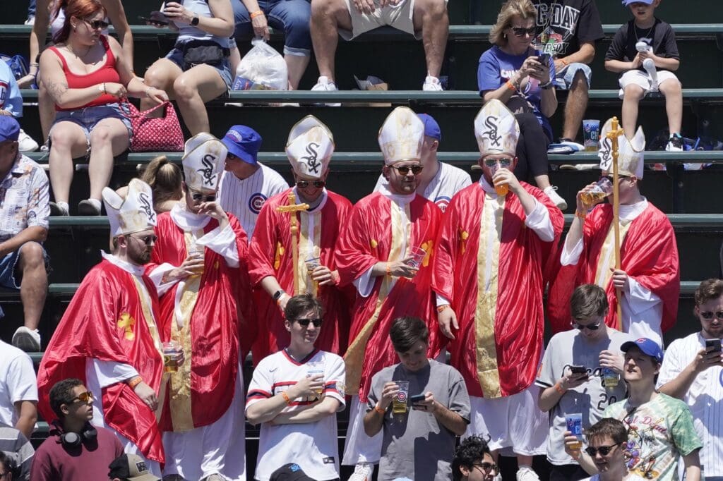 May 16, 2025; Chicago, Illinois, USA; Chicago White Sox fans dressed like Pope Leo XIV in the bleachers during a game between the Chicago Cubs and the Chicago White Sox at Wrigley Field.