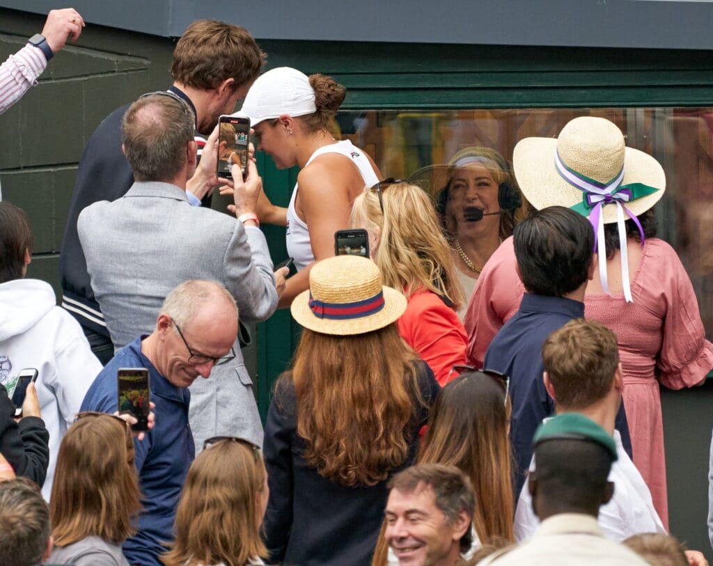 Jul 10, 2021; London, United Kingdom; Ashleigh Barty (AUS) climbing past the TV studio watched by Chrissie Evert on her way to the player s box above after her women s final at All England Lawn Tennis and Croquet Club.