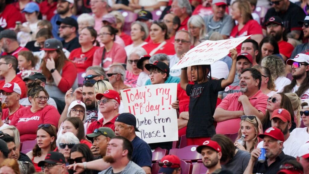 Cincinnati Reds fans hold signs during the MLB game between the Cincinnati Reds and Milwaukee Brewers, Tuesday, June 3, 2025, at Great American Ball Park in Downtown Cincinnati.