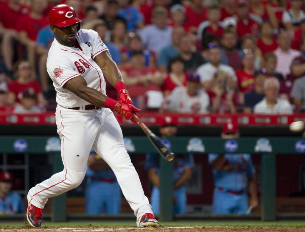 Cincinnati Reds right fielder Yasiel Puig (66) hits a double to score Eugenio Suarez in the bottom of the seventh inning of the MLB game between Cincinnati Reds and St. Louis Cardinals on Saturday, July 20, 2019, in Cincinnati.