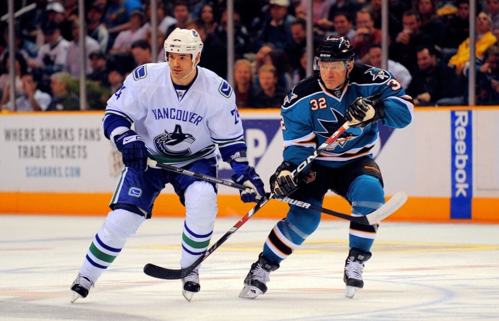 Jan. 20, 2009; San Jose, CA, USA; San Jose Sharks right wing Claude Lemieux (32) fights for position with Vancouver Canucks left wing Darcy Hordichuk (left) during the first period at HP Pavilion.