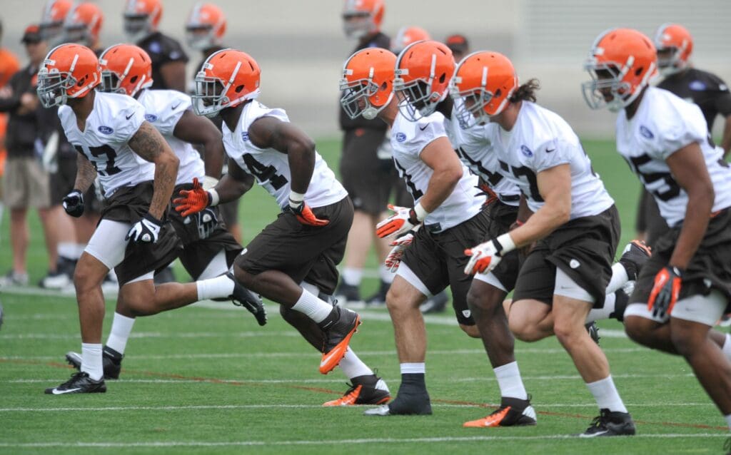 May 10, 2013; Berea, OH, USA; Cleveland Browns linebacker Ausar Walcott (left) sprints with the team during rookie minicamp at the Cleveland Browns Training Facility