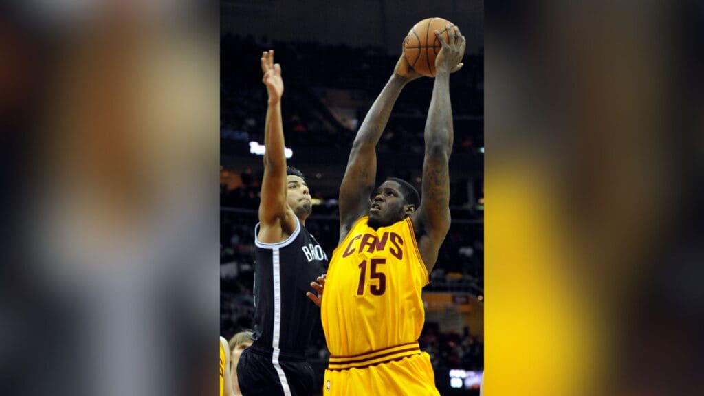 Apr 12, 2014; Cleveland, OH, USA; Cleveland Cavaliers forward Anthony Bennett (15) shoots against Brooklyn Nets guard Jorge Gutierrez (13) in the third quarter at Quicken Loans Arena.