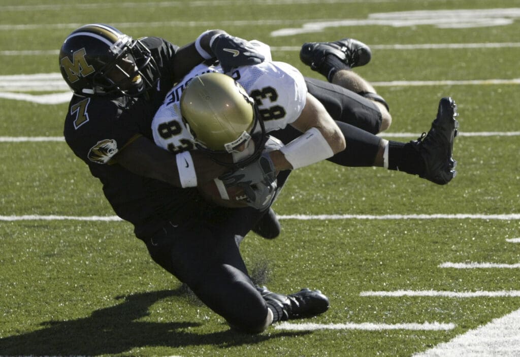 Oct 2, 2004; Columbia, MO, USA; Wide receiver Dusty Sprague #86 of the University of Colorado Buffalos is tackled by corner back A.J. Kincade #7 of the University of Missouri Tigers at Memorial Stadium in Columbia, Mo.