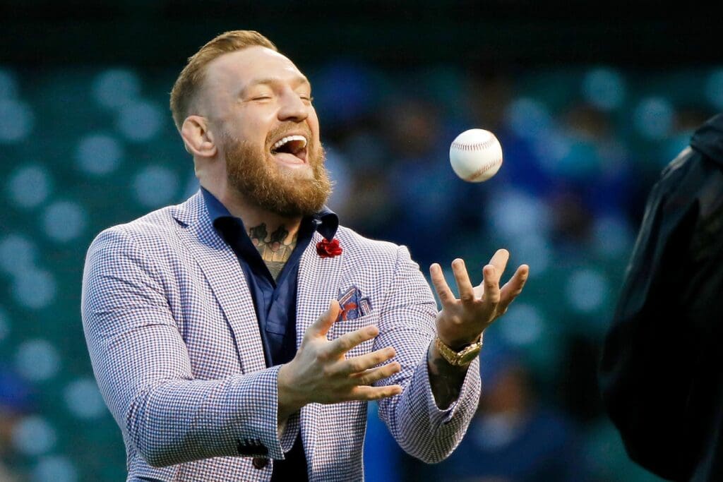 Sep 21, 2021; Chicago, Illinois, USA; MMA fighter Conor McGregor tosses the ball after throwing out a ceremonial first pitch before the game between the Chicago Cubs and the Minnesota Twins at Wrigley Field