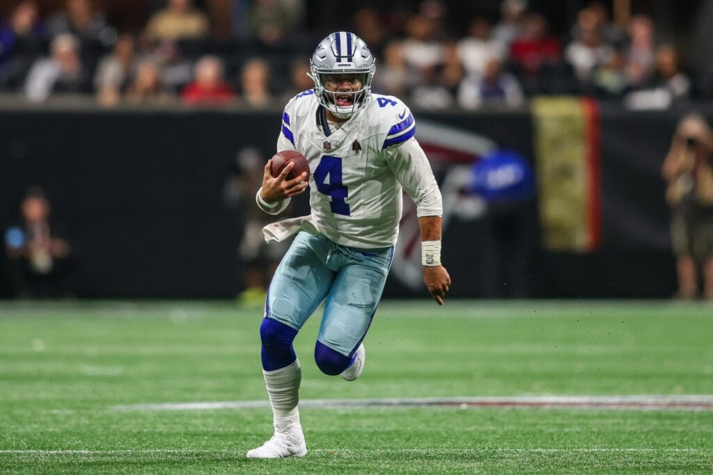 Nov 3, 2024; Atlanta, Georgia, USA; Dallas Cowboys quarterback Dak Prescott (4) scrambles against the Atlanta Falcons in the third quarter at Mercedes-Benz Stadium.