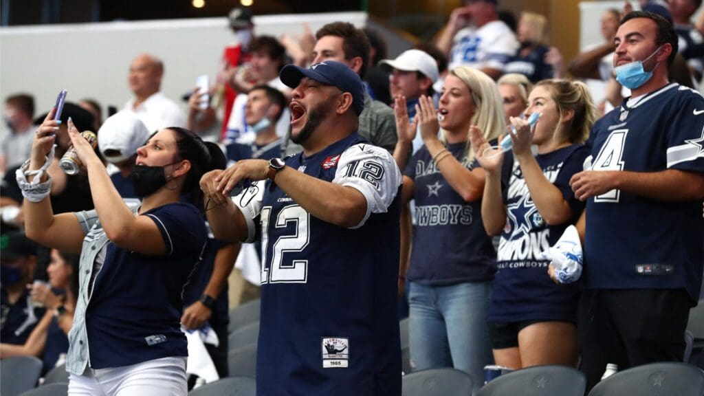 Sep 20, 2020; Arlington, Texas, USA; Dallas Cowboys fans do not wear mask while cheering during the game against the Atlanta Falcons at AT&T Stadium.