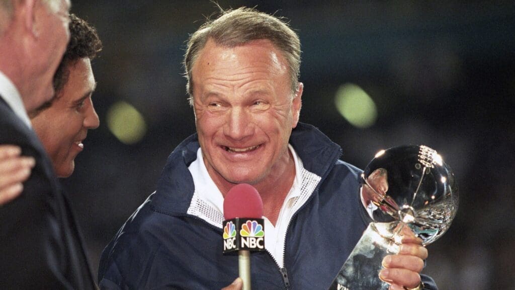 Jan 28, 1996; Tempe, AZ, USA; FILE PHOTO; Dallas Cowboys head coach Barry Switzer holds the Lombardi trophy while talking to NBC sportscaster Greg Gumbel after a victory against the Pittsburgh Steelers in Super Bowl XXX at Sun Devil Stadium. Dallas defeated Pittsburgh 27-17