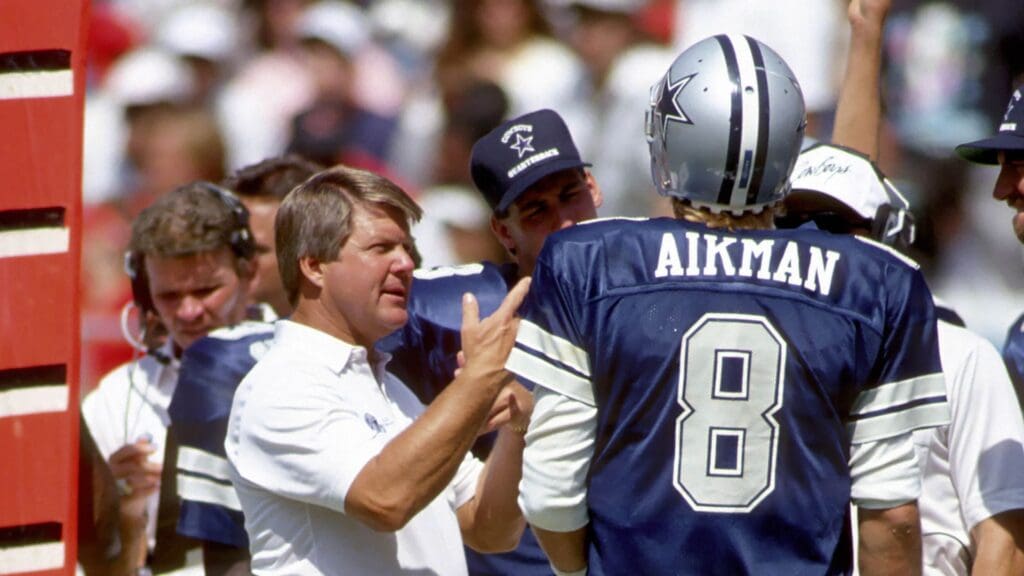 Dallas Cowboys head coach Jimmy Johnson and quarterback (8) Troy Aikman talk on the sideline against the Atlanta Falcons at Fulton County Stadium.