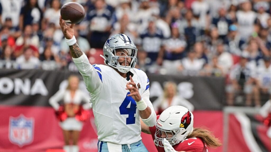 Sep 24, 2023; Glendale, Arizona, USA; Dallas Cowboys quarterback Dak Prescott (4) throws while being tackled by Arizona Cardinals linebacker Dennis Gardeck (45) in the first half at State Farm Stadium.