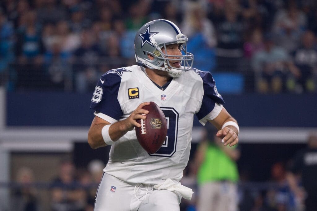 Nov 26, 2015; Arlington, TX, USA; Dallas Cowboys quarterback Tony Romo (9) rolls out to pass during the game against the Carolina Panthers on Thanksgiving at AT&T Stadium. The Panthers defeat the Cowboys 33-14.