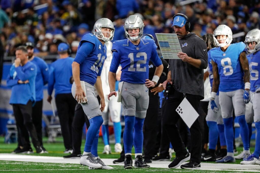 Lions quarterback Jared Goff, left, talks to quarterback Tim Boyle and coach Dan Campbell at a timeout during the second half of the Lions' 37-30 win over the Packers on Sunday, Jan. 9, 2022, at Ford Field.