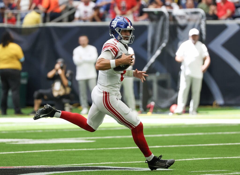 Aug 17, 2024; Houston, Texas, USA; New York Giants quarterback Daniel Jones (8) scrambles 16 yards for a first down against the Houston Texans in the first quarter at NRG Stadium.