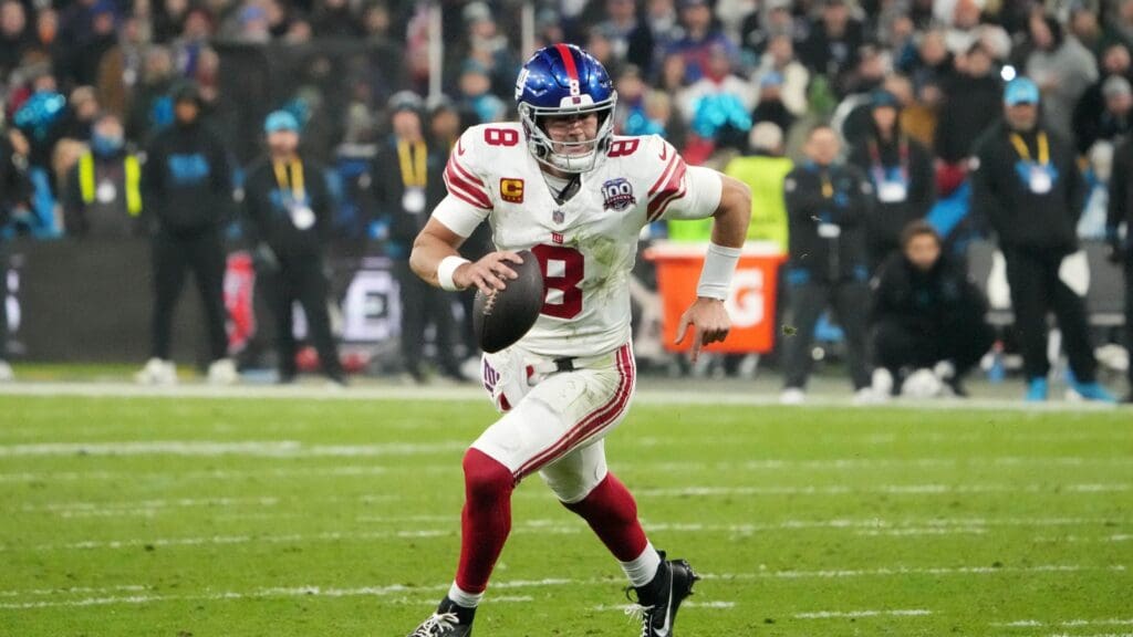 Nov 10, 2024; Munich, Germany; New York Giants quarterback Daniel Jones (8) carries the ball against the New York Giants in the second half during the 2024 NFL Munich Game at Allianz Arena.