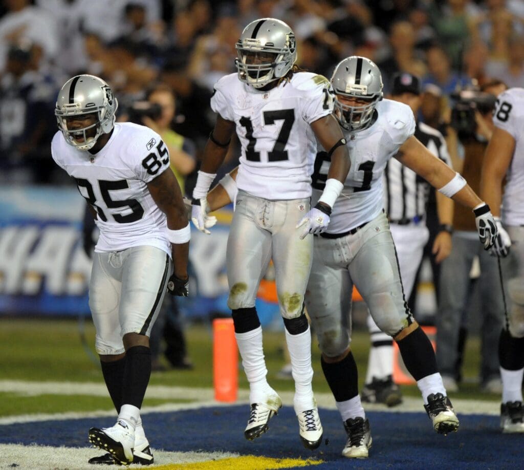 Nov 10, 2011; San Diego, CA, USA; Oakland Raiders receiver Denarius Moore (17), center, celebrates with receiver Darius Heyward-Bey (85), left, and guard Stefen Wisniewski (61) after scoring on a 33-yard touchdown reception in the second quarter against the San Diego Chargers at Qualcomm Stadium.