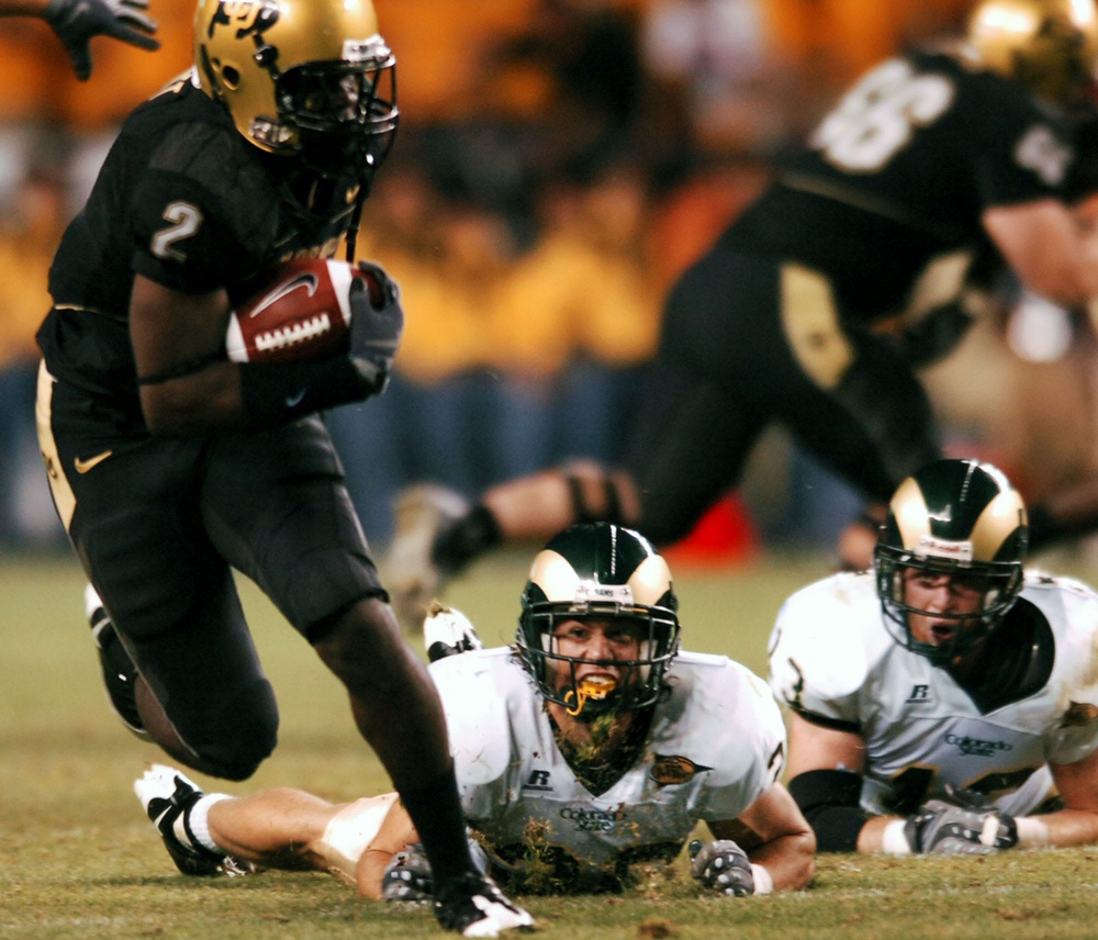 University of Colorado tailback Darrell Scott (2), left, breaks free of Colorado State University defenders Klint Kubiak (20), center, and Mike Pagnotta (13) in the second quarter of action at Invesco Field in Denver on Aug. 31, 2008.