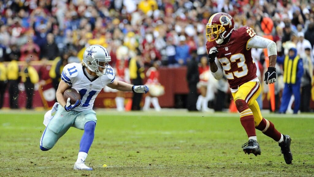 Dec 8, 2013; Landover, MD, USA; Dallas Cowboys wide receiver Cole Beasley (11) runs with the ball as Washington Redskins cornerback DeAngelo Hall (23) chases during the second half at FedEx Field