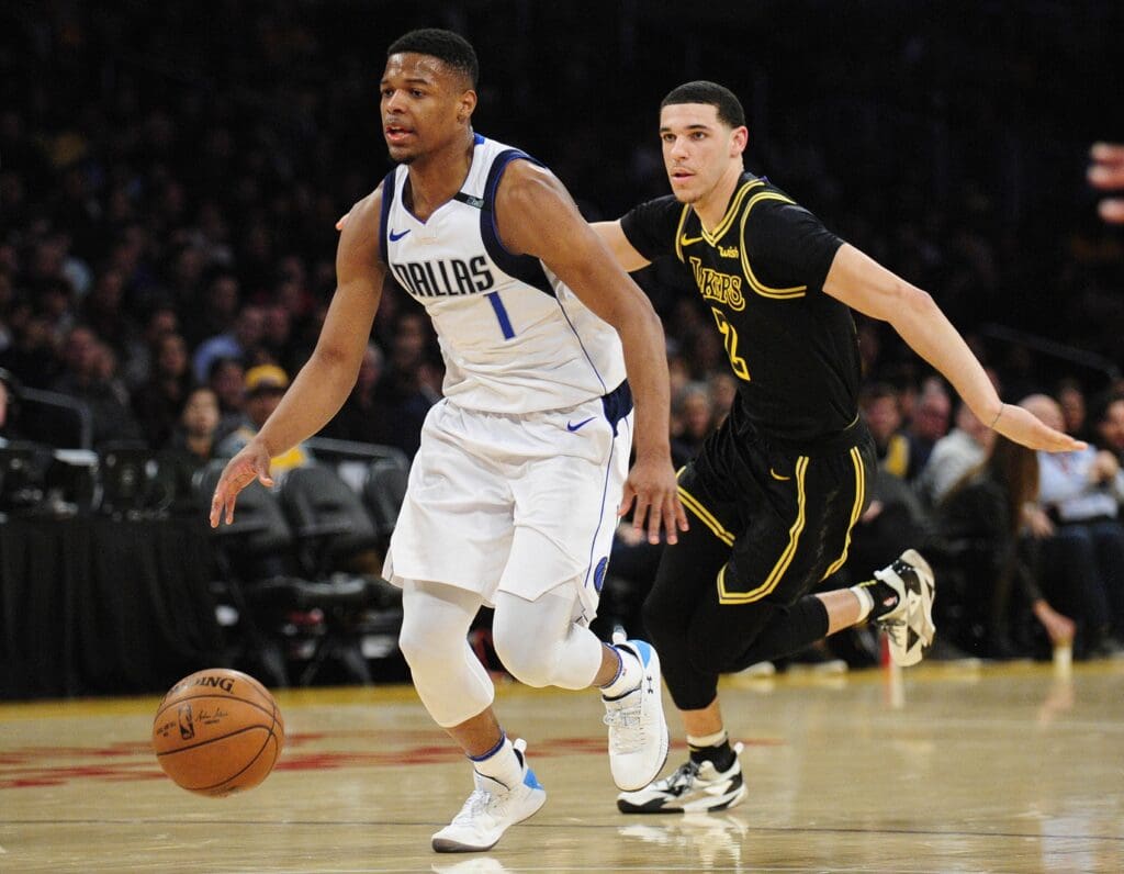 February 23, 2018; Los Angeles, CA, USA; Dallas Mavericks guard Dennis Smith Jr. (1) moves the ball ahead of Los Angeles Lakers guard Lonzo Ball (2) during the first half at Staples Center.